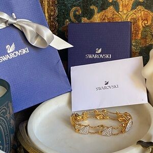 Swarovski gold tone swan link bracelet with box, certificate and bag
